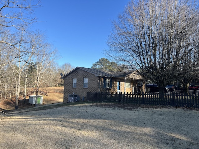 view of front of home featuring a front yard and cooling unit