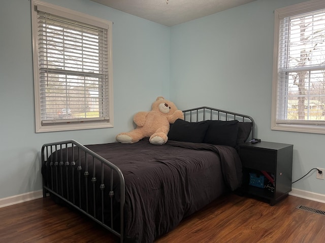 bedroom featuring dark hardwood / wood-style flooring