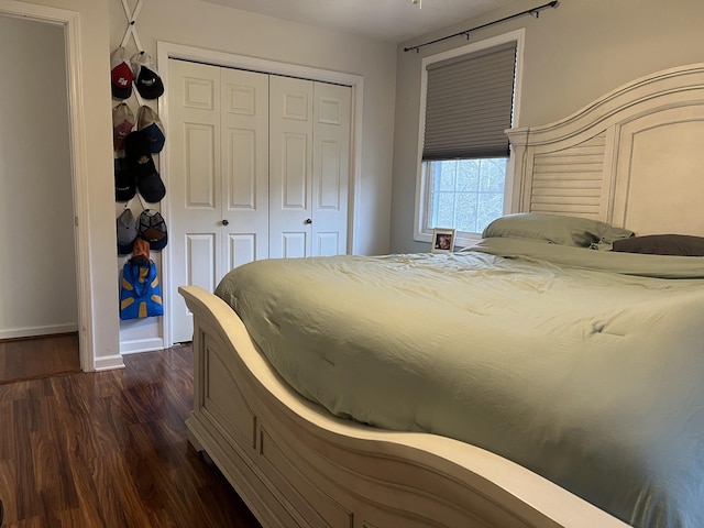 bedroom with a closet and dark hardwood / wood-style flooring