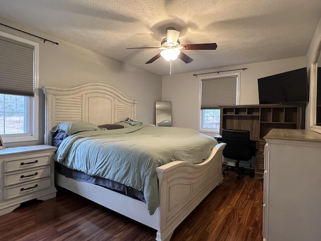 bedroom featuring ceiling fan, dark hardwood / wood-style flooring, and a textured ceiling