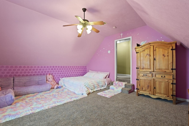 bedroom with ceiling fan, dark carpet, and lofted ceiling