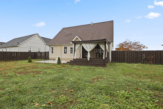 rear view of house featuring a lawn and a patio area