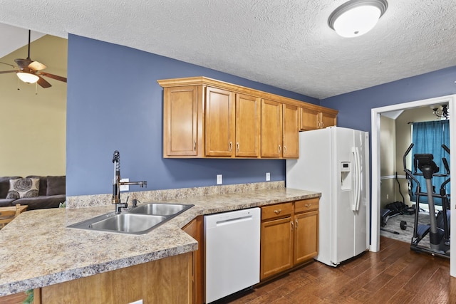 kitchen featuring ceiling fan, white appliances, dark wood-type flooring, a textured ceiling, and sink