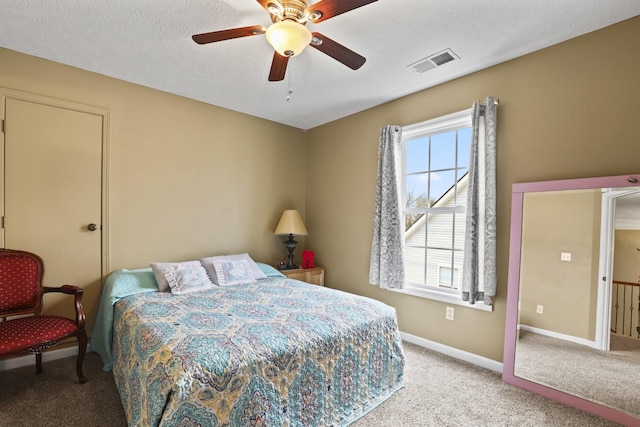 bedroom with light carpet, ceiling fan, and a textured ceiling