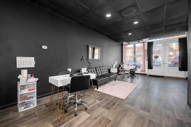 office area with hardwood / wood-style floors, a drop ceiling, and french doors