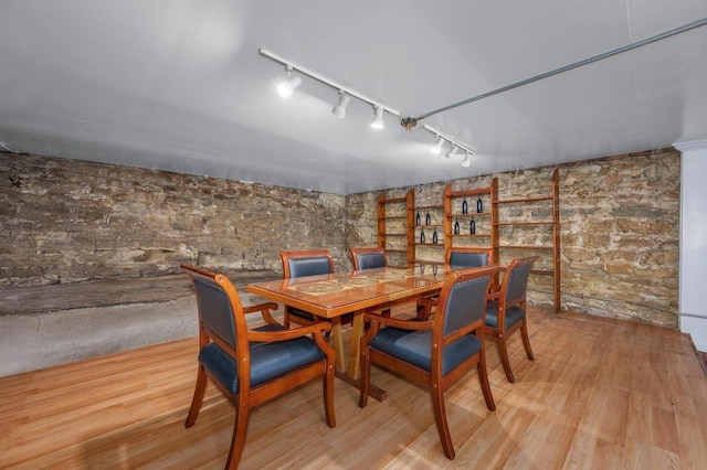 dining room with rail lighting and light wood-type flooring