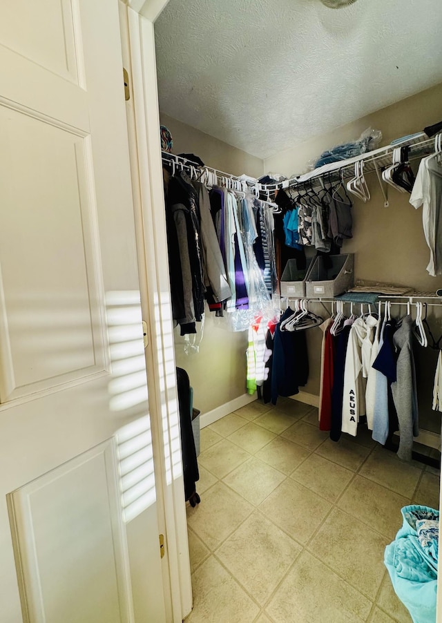 spacious closet with light tile patterned floors