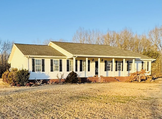 single story home with a front lawn and a porch