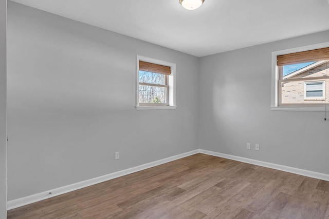 empty room with hardwood / wood-style floors