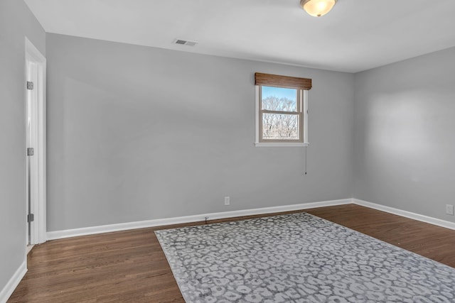 empty room featuring dark wood-type flooring