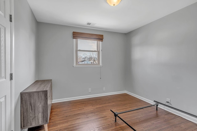 spare room with hardwood / wood-style floors