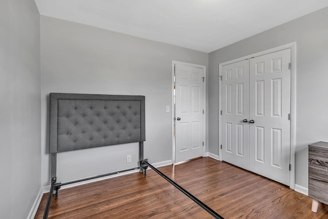 bedroom featuring a closet and dark hardwood / wood-style flooring