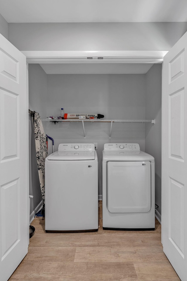 washroom featuring separate washer and dryer and light wood-type flooring