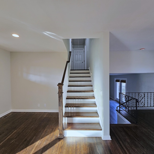 staircase with hardwood / wood-style flooring