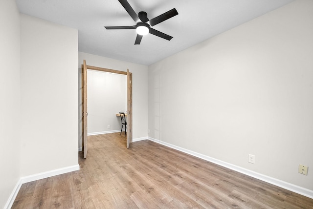 empty room with ceiling fan and light wood-type flooring