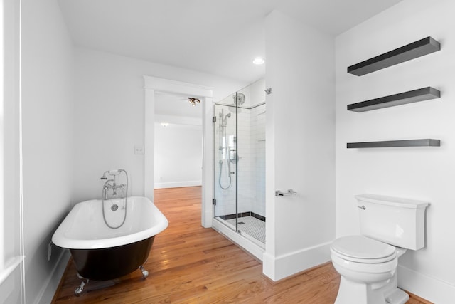 bathroom featuring toilet, independent shower and bath, and hardwood / wood-style floors