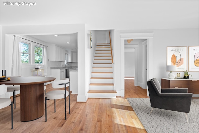 dining space featuring light hardwood / wood-style flooring and sink