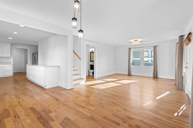 unfurnished living room with light hardwood / wood-style floors