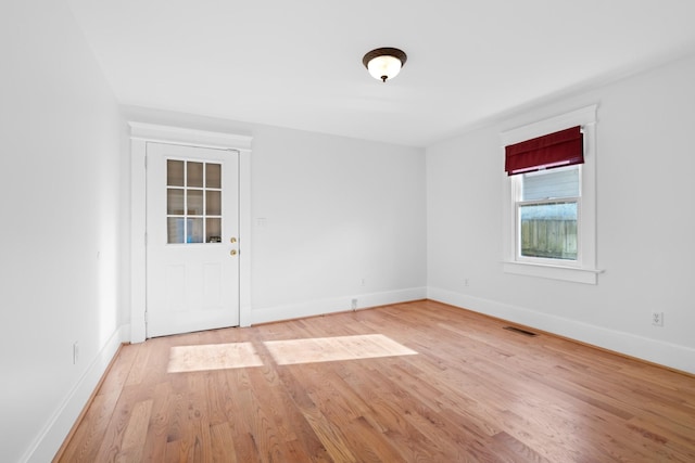 spare room featuring light wood-type flooring