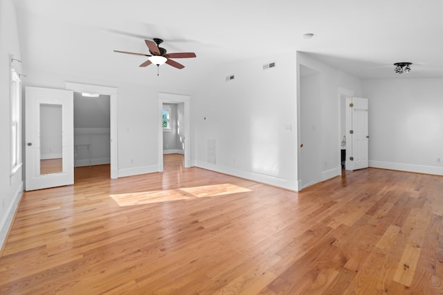 unfurnished room with light hardwood / wood-style floors, ceiling fan, and vaulted ceiling