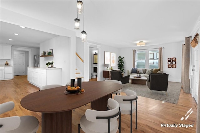 dining space with light hardwood / wood-style floors