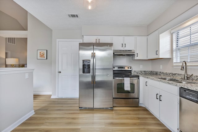 kitchen with sink, white cabinetry, stainless steel appliances, and a textured ceiling