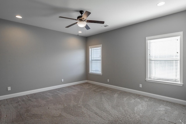 carpeted spare room with ceiling fan