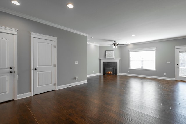 unfurnished living room featuring ceiling fan, a fireplace, dark hardwood / wood-style flooring, and crown molding