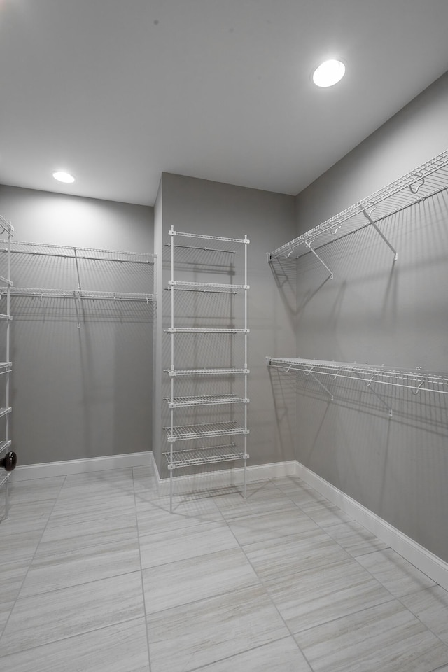 spacious closet featuring tile patterned floors