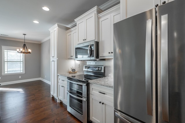 kitchen featuring hanging light fixtures, dark wood-type flooring, stainless steel appliances, white cabinets, and light stone counters