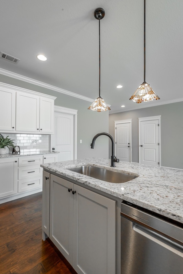 kitchen featuring dishwasher, sink, white cabinetry, and pendant lighting