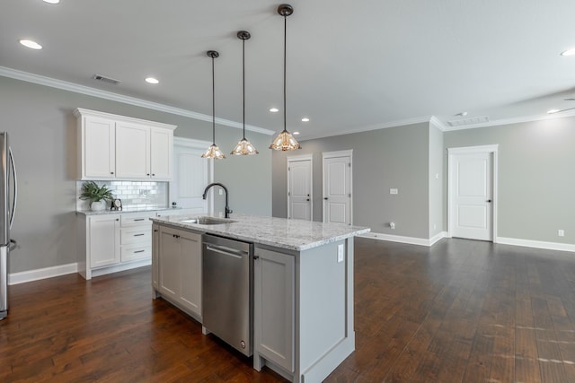 kitchen featuring sink, white cabinetry, light stone countertops, an island with sink, and stainless steel appliances