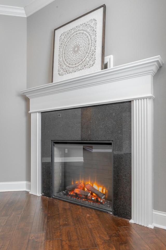 interior details with ornamental molding and hardwood / wood-style floors