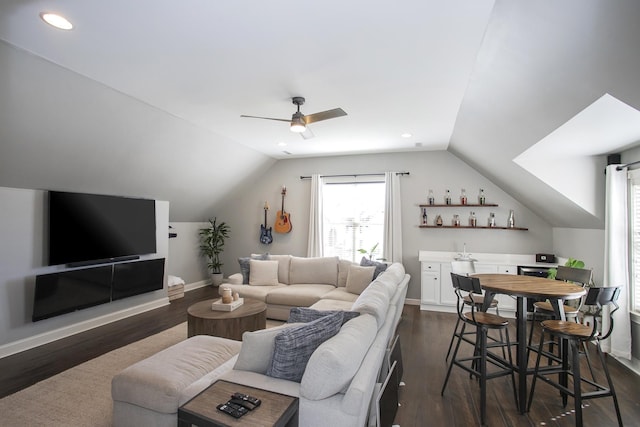 living room with bar, ceiling fan, dark hardwood / wood-style flooring, lofted ceiling, and beverage cooler