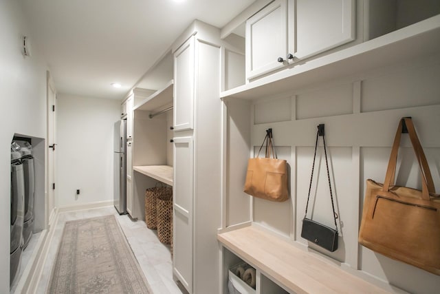 mudroom with washer and clothes dryer