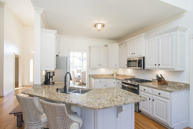 kitchen with sink, white cabinetry, and appliances with stainless steel finishes