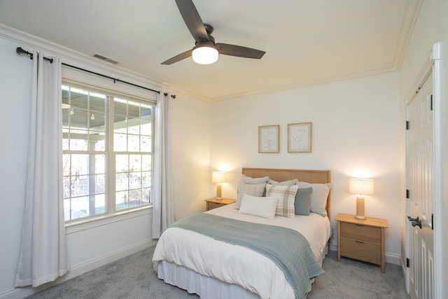 carpeted bedroom featuring ceiling fan, multiple windows, and crown molding