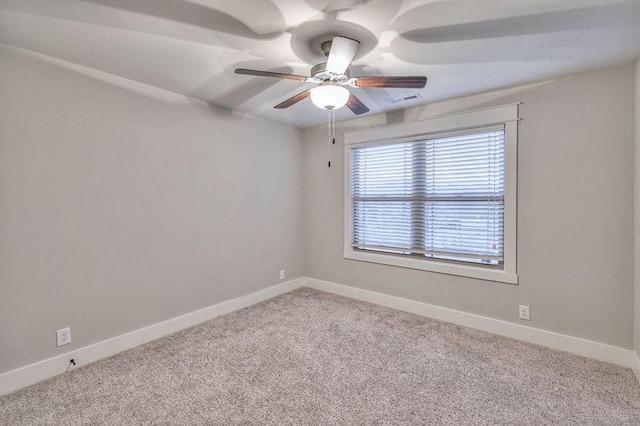 carpeted empty room featuring ceiling fan