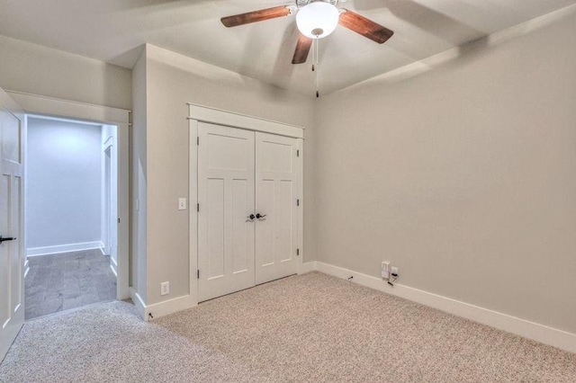 unfurnished bedroom with light carpet, ceiling fan, and a closet