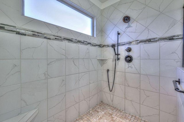 bathroom with a tile shower