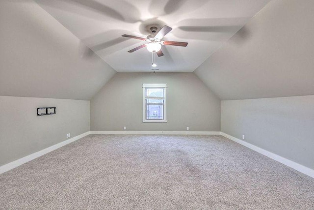 additional living space featuring vaulted ceiling, ceiling fan, and carpet flooring