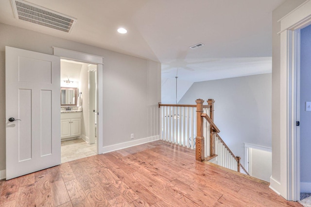 interior space with vaulted ceiling and light wood-type flooring