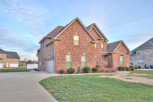 view of property featuring a front yard and a garage