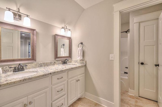 bathroom featuring vanity and lofted ceiling