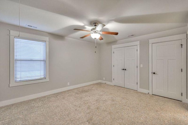 unfurnished bedroom featuring ceiling fan and light colored carpet