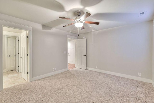 empty room featuring ceiling fan and light colored carpet