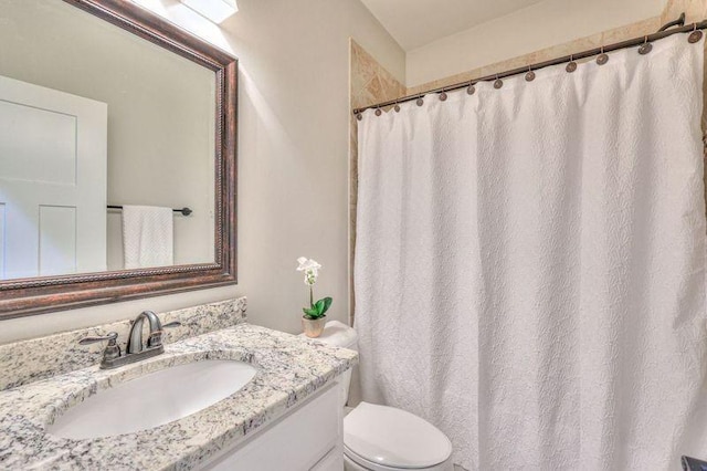 bathroom with toilet and vanity