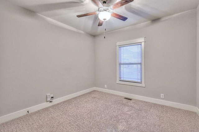 carpeted spare room featuring ceiling fan