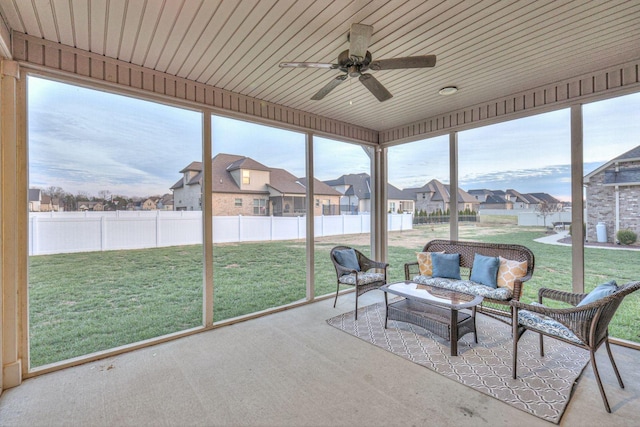 unfurnished sunroom featuring ceiling fan