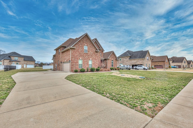 view of front of house featuring brick siding, concrete driveway, an attached garage, a front yard, and fence